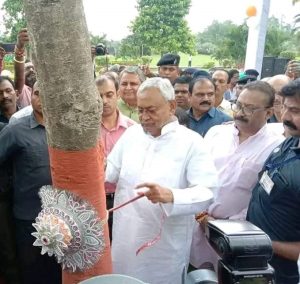 Bihar Chief Minister Nitish Kumar ties Rakhi to a tree in Patna