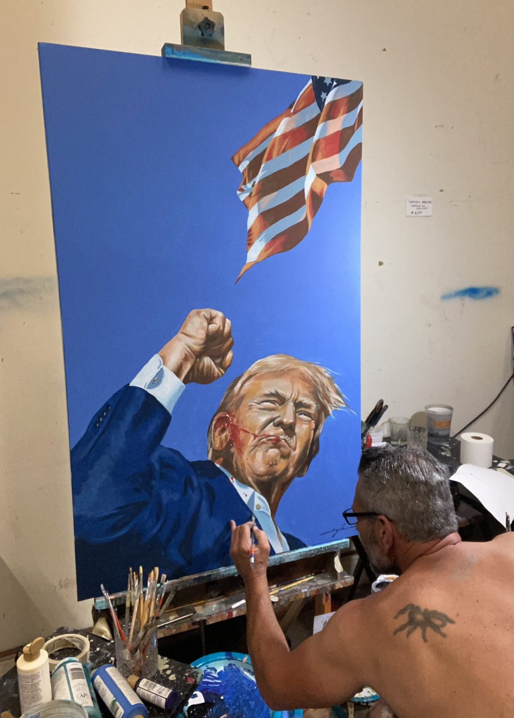 A painter draws sketch of former US president Donald Trump