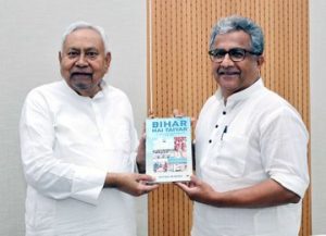 Bihar Minister Nitish Mishra presents a book to CM Nitish Kumar!
