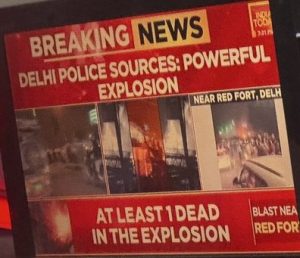 TV screens showing Delhi blast as breaking news.