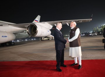 Prime Minister Narendra Modi welcomes Russian President Vladimir Putin at New Delhi airport.