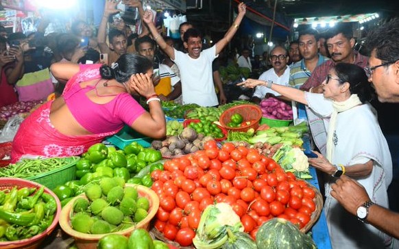 West Bengal CM Mamata Banerjee at a vegetable shop in Kolkata on Sunday evening..