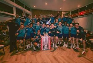Arsenal players celebrating together after securing the Premier League title.