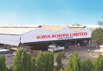 Exterior view of the Surya Roshni manufacturing facility with industrial infrastructure and production units at the company factory.