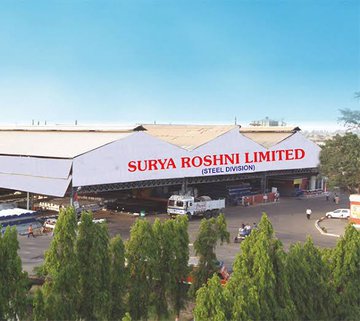 Exterior view of the Surya Roshni manufacturing facility with industrial infrastructure and production units at the company factory.