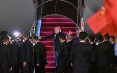 Russian President Vladimir Putin departs after concluding his visit to China, walking near the aircraft staircase with officials and security personnel visible at the departure area.
