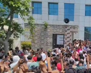 Students waiting outside a CUET examination centre amid delays caused by a technical glitch, highlighting concerns over India's examination infrastructure.