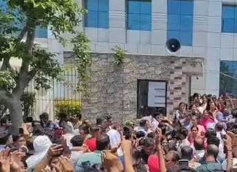 Students waiting outside a CUET examination centre amid delays caused by a technical glitch, highlighting concerns over India's examination infrastructure.