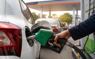 A petrol pump dispensing E20 fuel in India alongside vehicles at a fuel station.