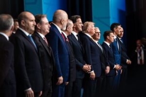 NATO leaders pose for the official family photograph at the NATO Summit, standing together in formal attire in front of the summit backdrop, representing member states and allied partners gathered to discuss collective security, defence spending and transatlantic cooperation.