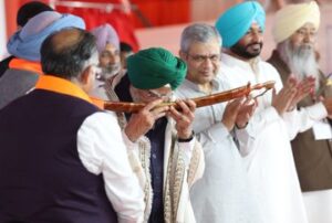 Prime Minister Narendra Modi wearing a green turban while addressing a public rally in Jalandhar, Punjab.