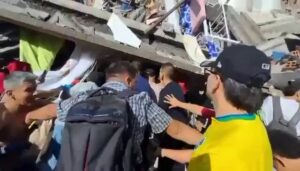 Rescue workers search rubble of a collapsed building after a 7.4-magnitude earthquake struck Cali, Colombia.