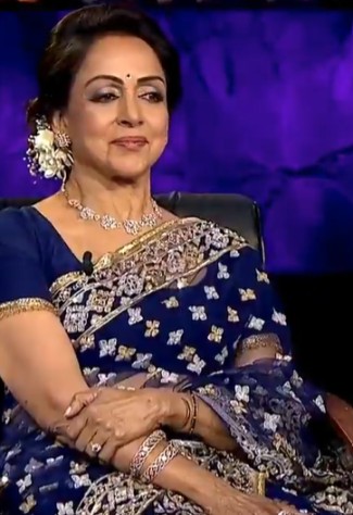 Hema Malini on the set of KBC hosted by Amitabh Bachchan.