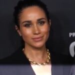 The Duchess of Sussex at a public event, shown in a news photograph accompanying a statement about her father.
