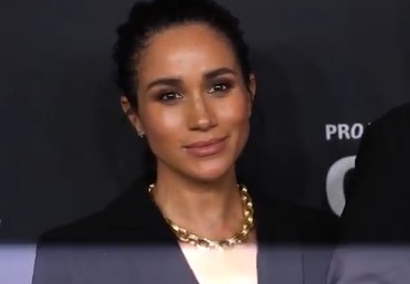 The Duchess of Sussex at a public event, shown in a news photograph accompanying a statement about her father.